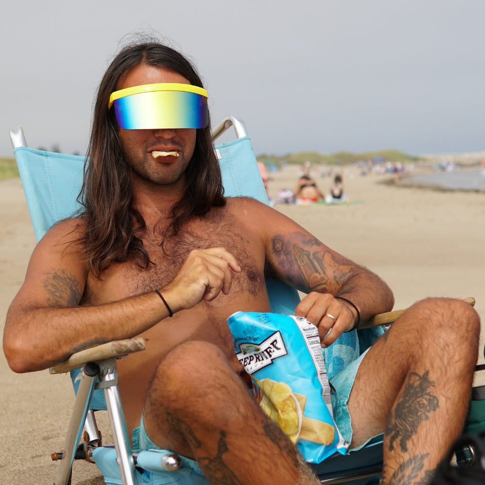 Jerry of the Dayglow Send-O-Vision 3.0 in yellow, man wearing at beach. Funny ski and snowboard gifts, shirts, and apparel.