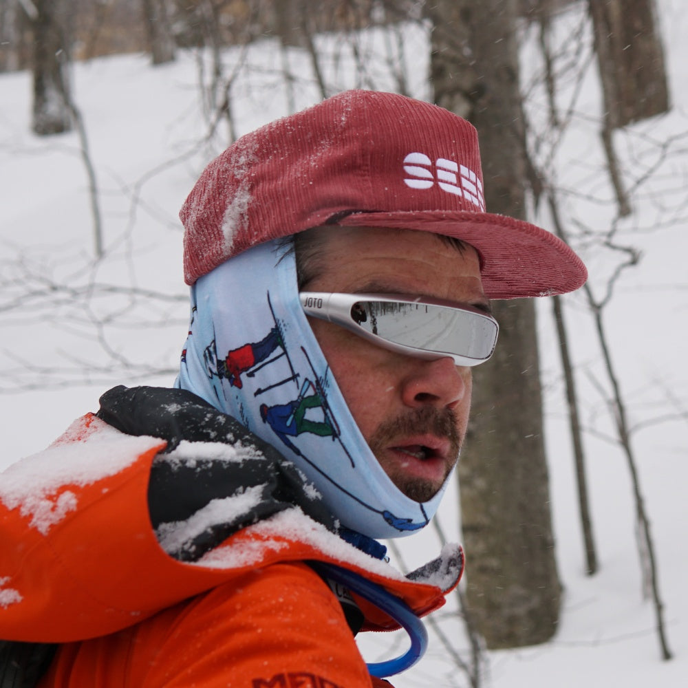 Jerry of the Day Send-O-Vision Jerry of the Day Glasses in silver, man wearing on snowy hike. Funny ski and snowboard gifts, shirts, and apparel.