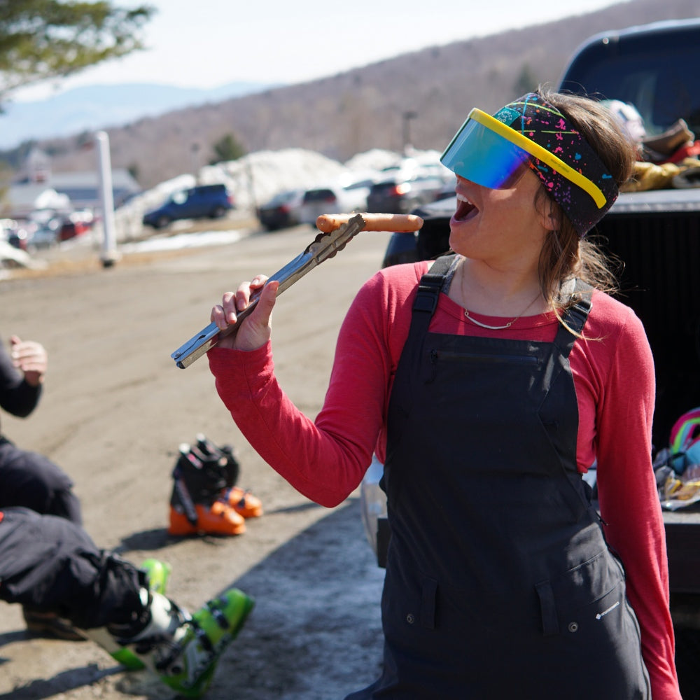 Jerry of the Dayglow Send-O-Vision 3.0 in yellow, woman eating hot dog. Funny ski and snowboard gifts, shirts, and apparel.
