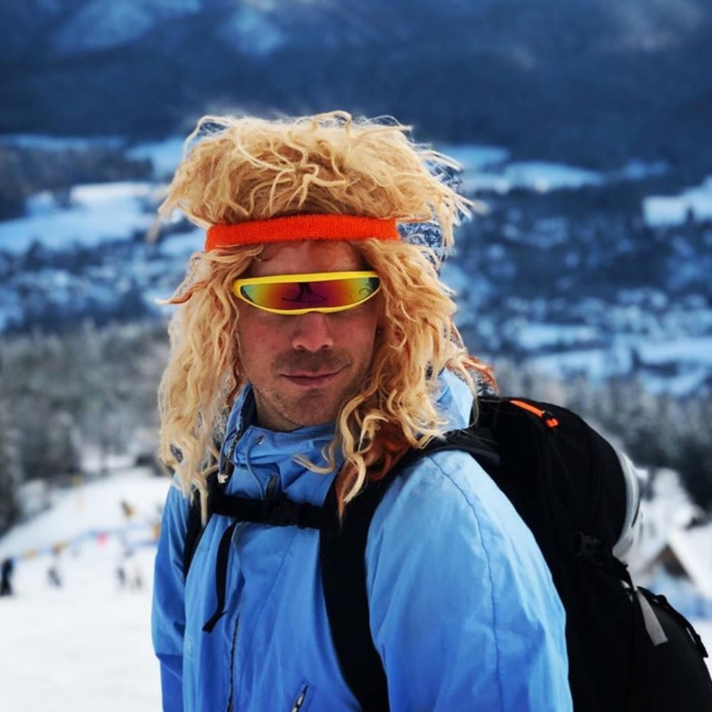 Jerry of the Day Send-O-Vision Jerry of the Day Glasses in yellow, man wearing on mountain with wig. Funny ski and snowboard gifts, shirts, and apparel.