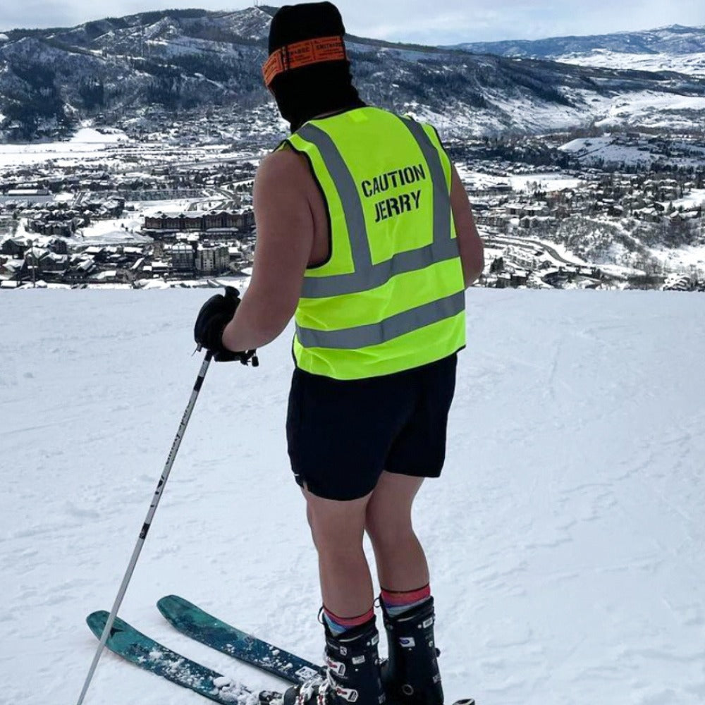 Jerry of the Day Caution Jerry Vest, man skiing on top of mountain.  Funny ski and snowboard gifts, shirts and apparel. 