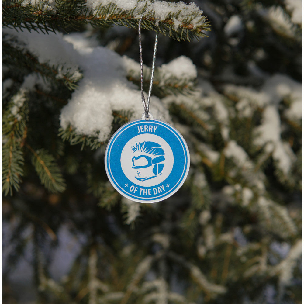 Jerry of the Day Logo Ornament, hanging in snowy tree. Funny ski and snowboard gifts, shirts, and apparel.