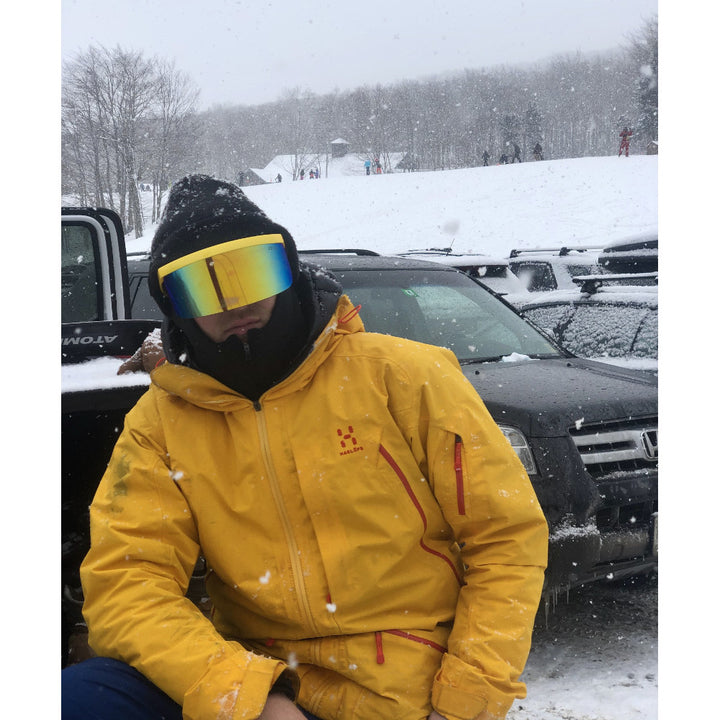 Jerry of the Dayglow Send-O-Vision 3.0 in yellow, man wearing in parking lot of ski resort. Funny ski and snowboard gifts, shirts, and apparel.
